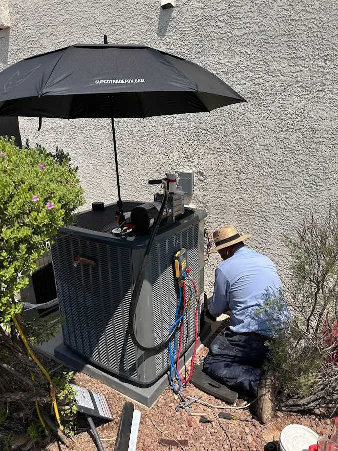 HVAC technician performing outdoor AC maintenance in Pleasant View